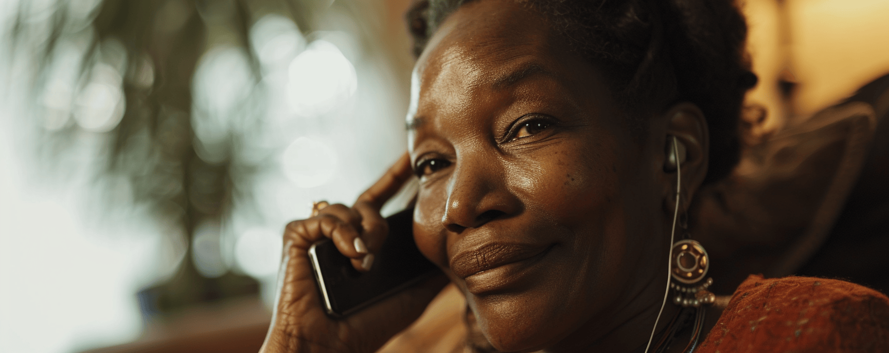 Black woman talking on phone using lifeline benefits